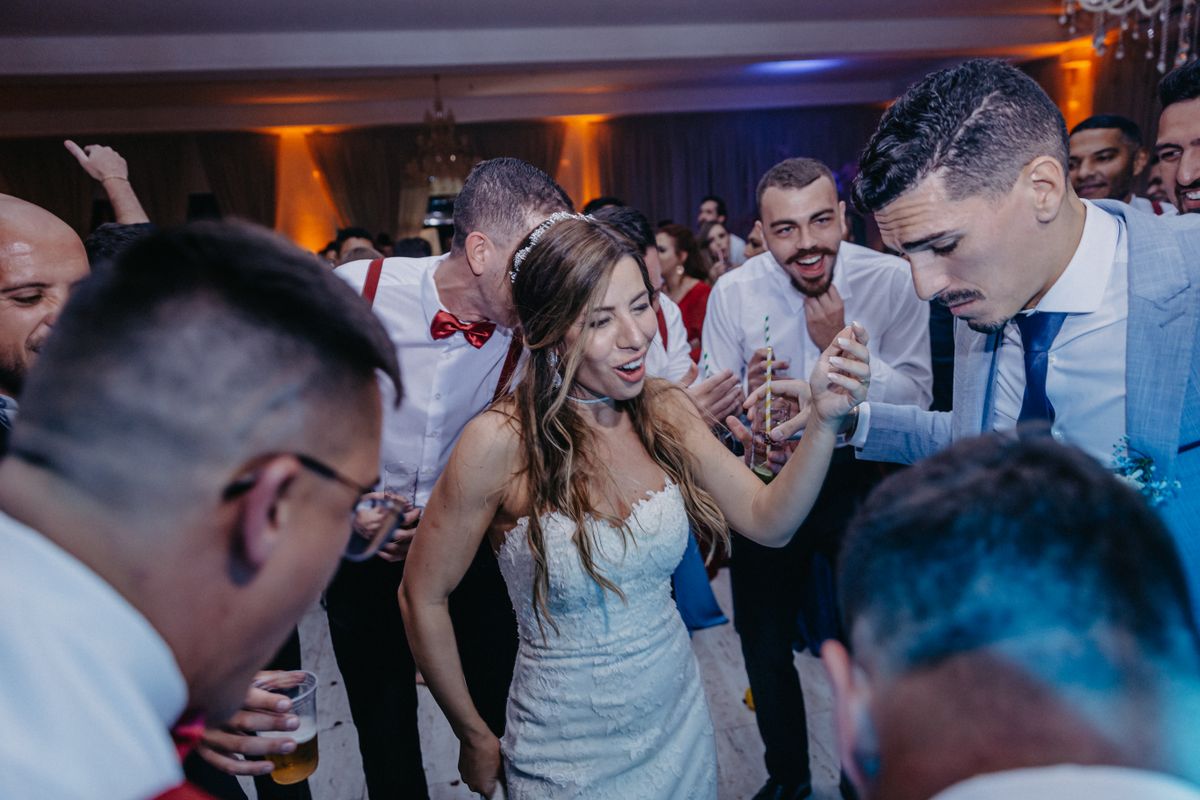Newlyweds and guests dancing