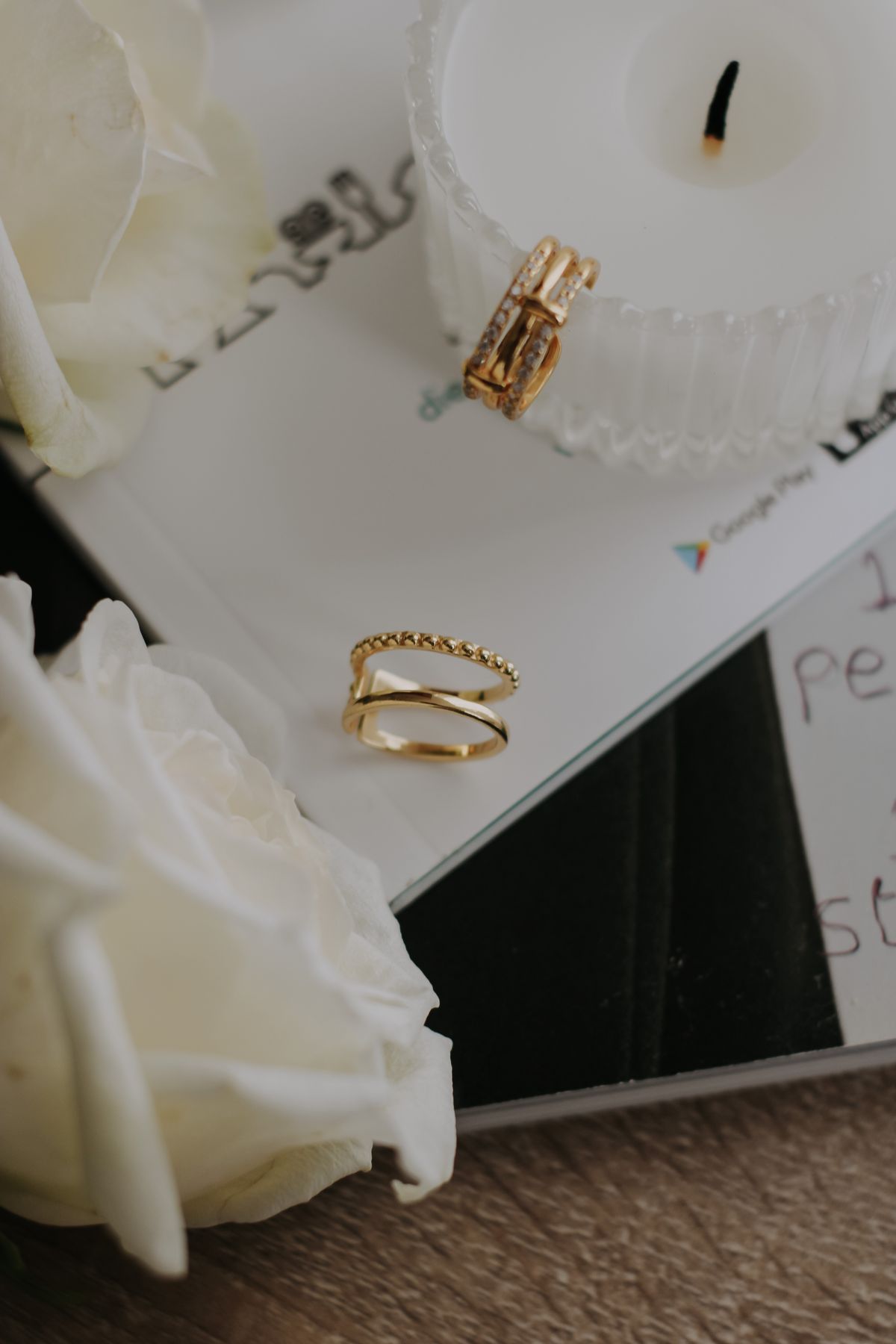 Gold rings and white roses