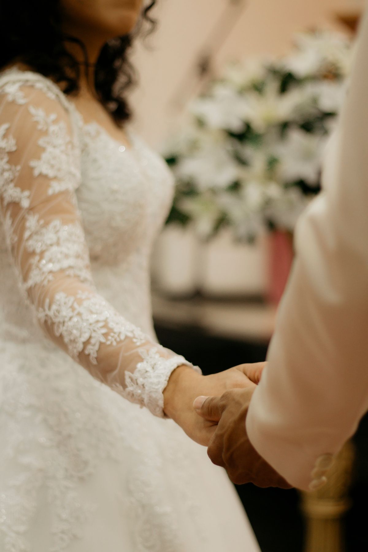 Bride and groom holding hands during ceremony