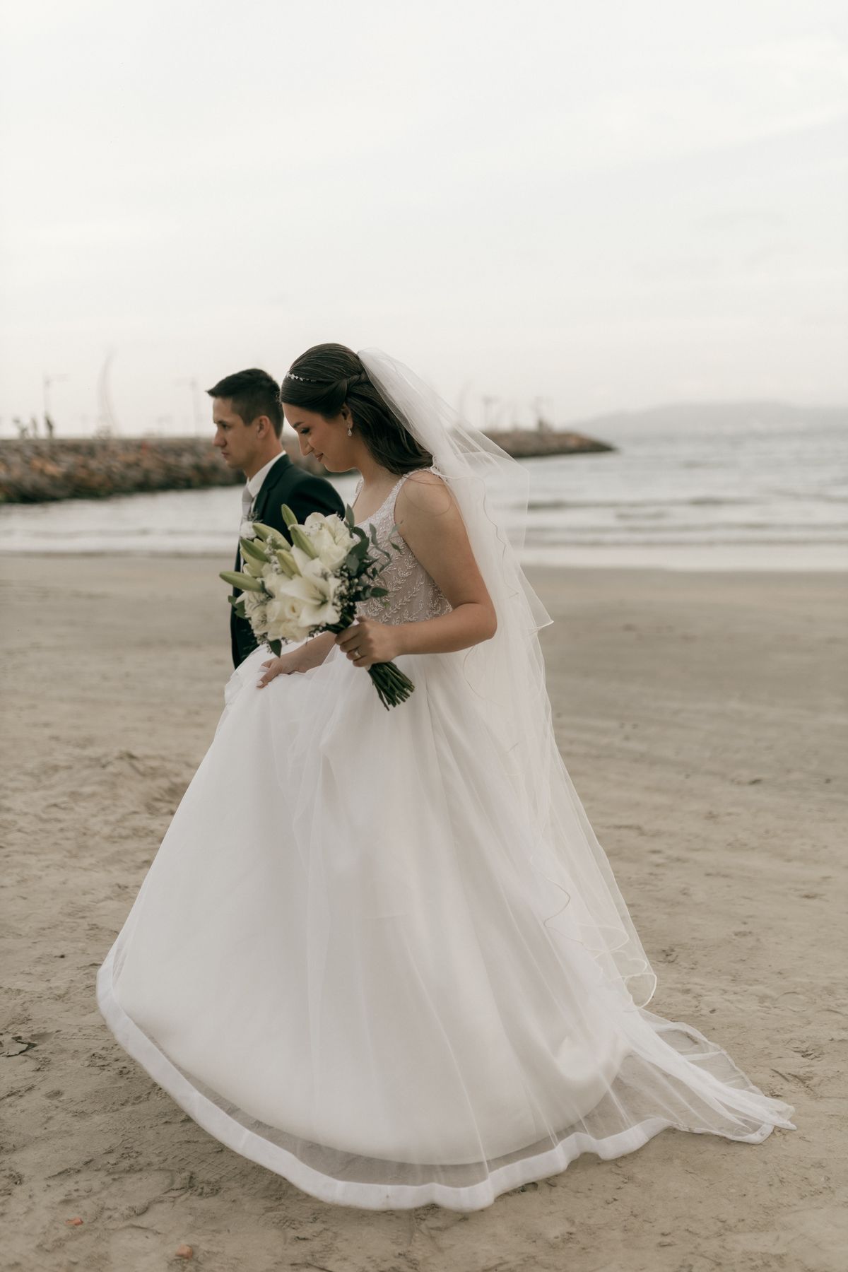 Bride and groom walking on a beach